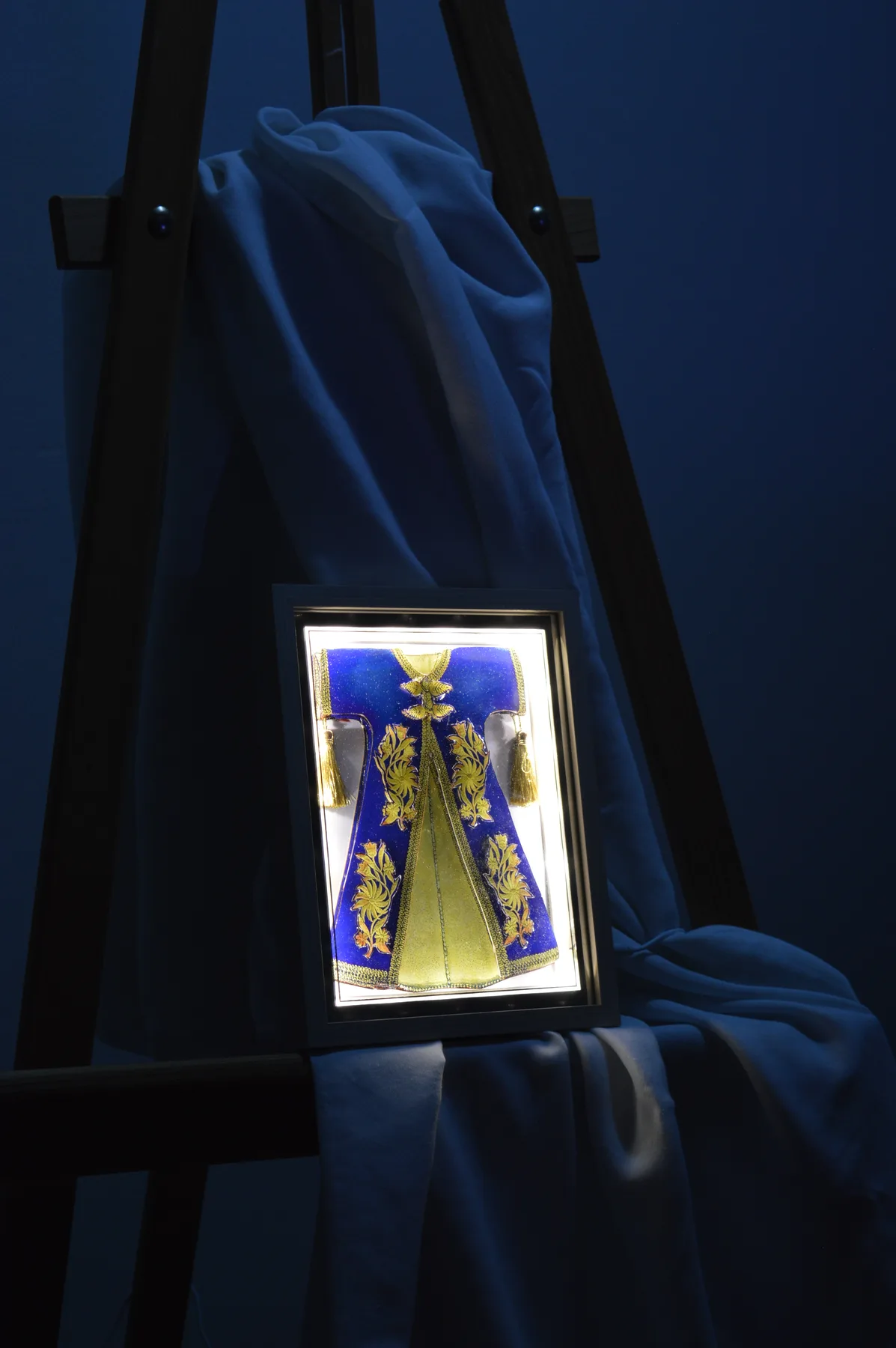 Illuminated blue and gold paper relief tableau